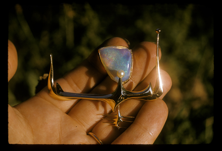 Ruth with pin, gold with opal, in Toza's hand, 1950s